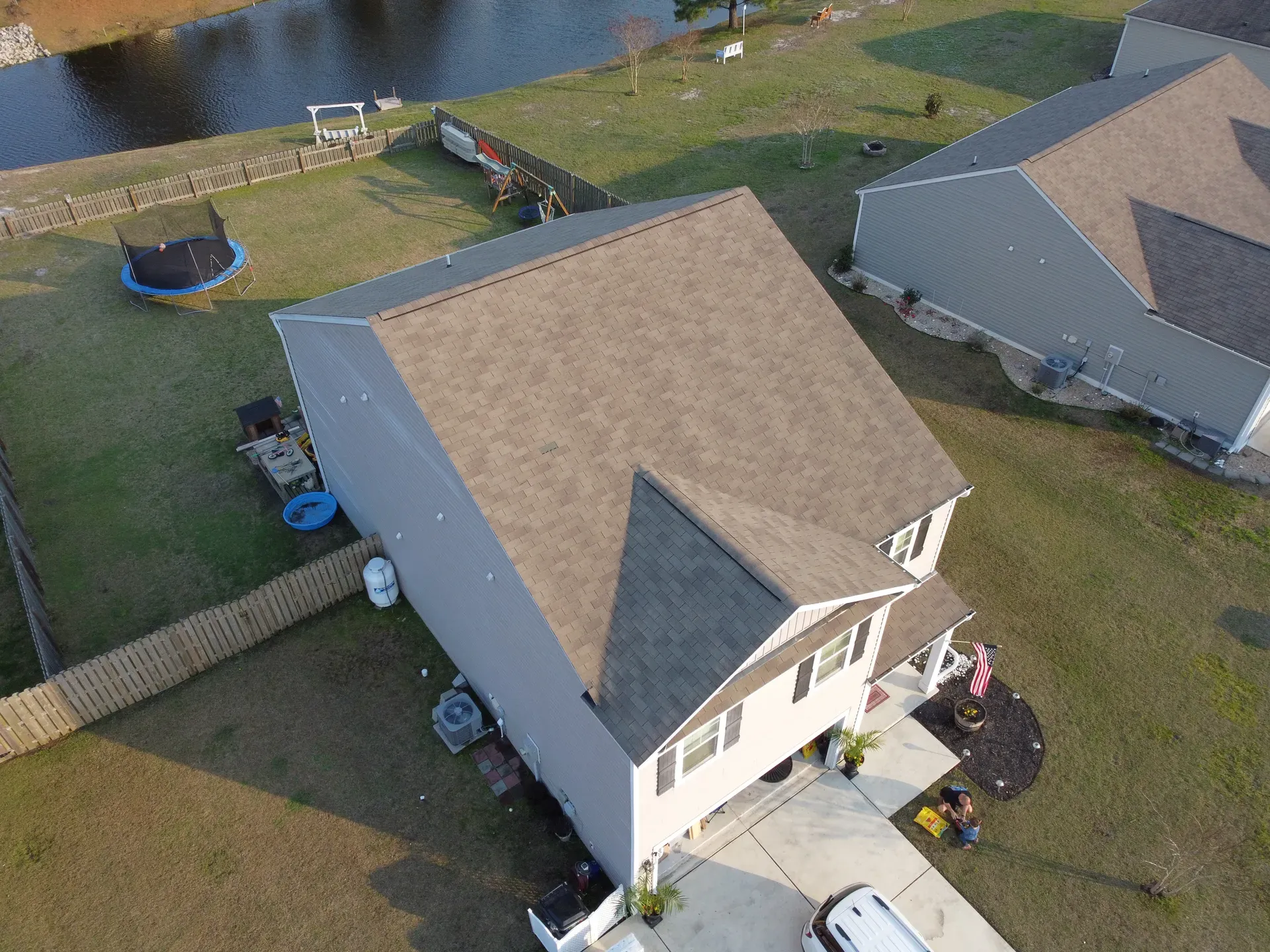 Aerial view of a house with a new roof installation in Bolivia, North Carolina